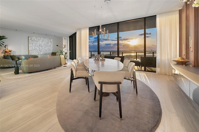 1000 Biscayne Blvd Unit 3201, Miami, FL 33132 - dining area featuring wood finished floors, a chandelier, a wall of windows, and healthy amount of natural light
