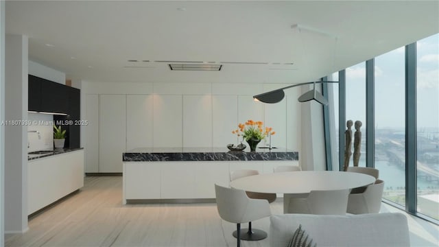 1000 Biscayne Blvd Unit 3201, Miami, FL 33132 - kitchen featuring expansive windows, white cabinetry, modern cabinets, and dark stone countertops