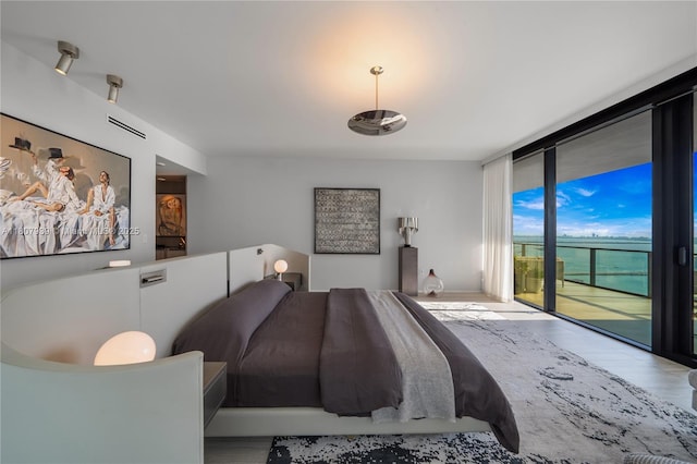 1000 Biscayne Blvd Unit 3201, Miami, FL 33132 - bedroom with expansive windows, access to exterior, and wood finished floors