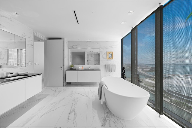 1000 Biscayne Blvd Unit 3201, Miami, FL 33132 - bathroom with a soaking tub, two vanities, marble finish flooring, healthy amount of natural light, and a wall of windows