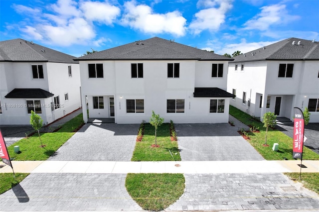22519 SW 125th Ave Unit B, Miami, FL 33170 - view of front of house with stucco siding, decorative driveway, a front yard, and a shingled roof