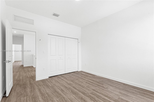 22519 SW 125th Ave Unit B, Miami, FL 33170 - unfurnished bedroom featuring wood finished floors, baseboards, and a closet