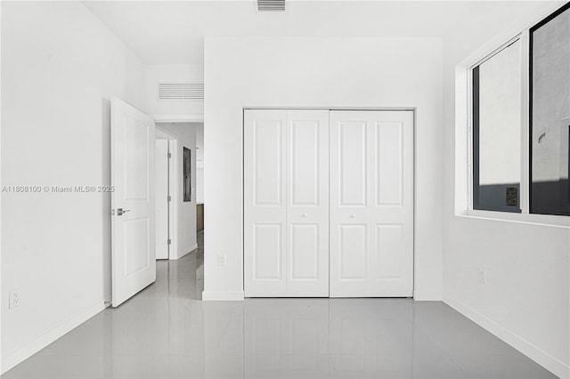 22519 SW 125th Ave Unit B, Miami, FL 33170 - unfurnished bedroom with baseboards, a closet, and tile patterned floors