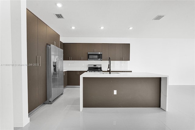 22519 SW 125th Ave Unit B, Miami, FL 33170 - kitchen featuring stainless steel appliances, a sink, dark brown cabinetry, light countertops, and recessed lighting