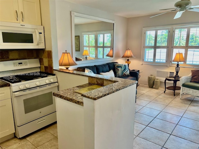 301 E Mcnab Rd Unit 205, Pompano Beach, FL 33060 - kitchen with white appliances, open floor plan, dark stone counters, light tile patterned flooring, and tasteful backsplash