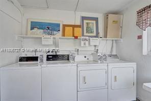 301 E Mcnab Rd Unit 205, Pompano Beach, FL 33060 - community laundry room featuring independent washer and dryer