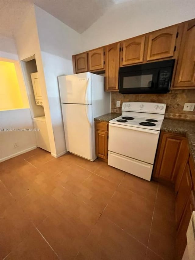 2421 NW 56th Ave Unit 2-202, Lauderhill, FL 33313 - kitchen with white appliances, tasteful backsplash, brown cabinetry, and lofted ceiling
