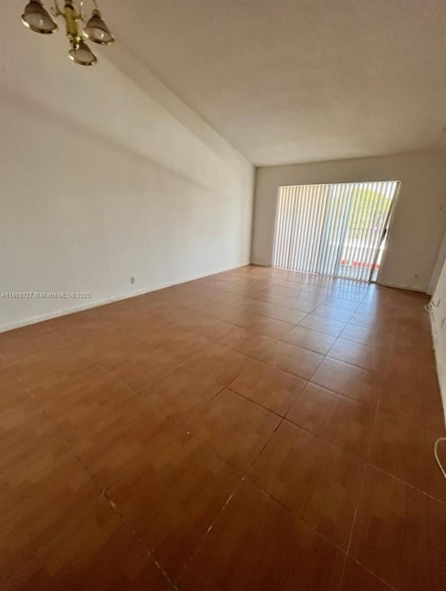 2421 NW 56th Ave Unit 2-202, Lauderhill, FL 33313 - spare room featuring a chandelier and tile patterned floors