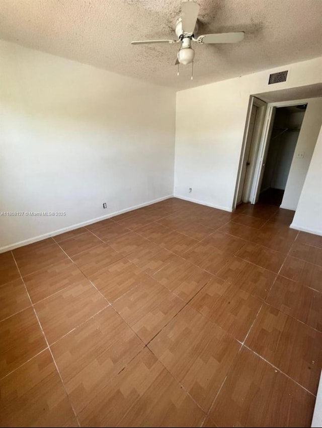2421 NW 56th Ave Unit 2-202, Lauderhill, FL 33313 - unfurnished room featuring a ceiling fan, a textured ceiling, and baseboards