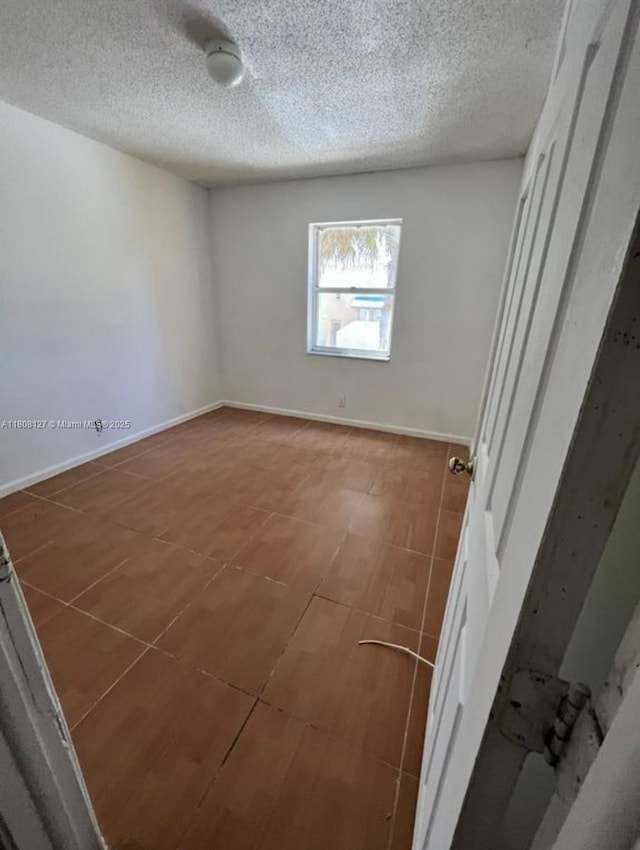 2421 NW 56th Ave Unit 2-202, Lauderhill, FL 33313 - empty room featuring a textured ceiling and baseboards