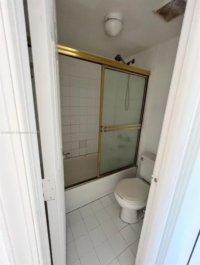 2421 NW 56th Ave Unit 2-202, Lauderhill, FL 33313 - bathroom featuring tile patterned floors, toilet, and bath / shower combo with glass door
