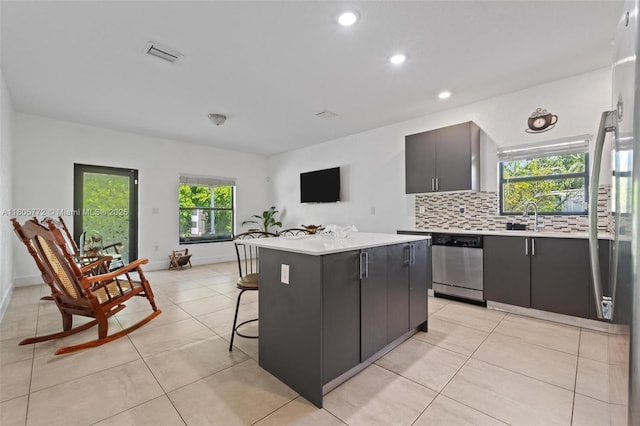 32004 SW 199th Ct, Homestead, FL 33030 - kitchen with stainless steel dishwasher, light countertops, a kitchen island, backsplash, and recessed lighting