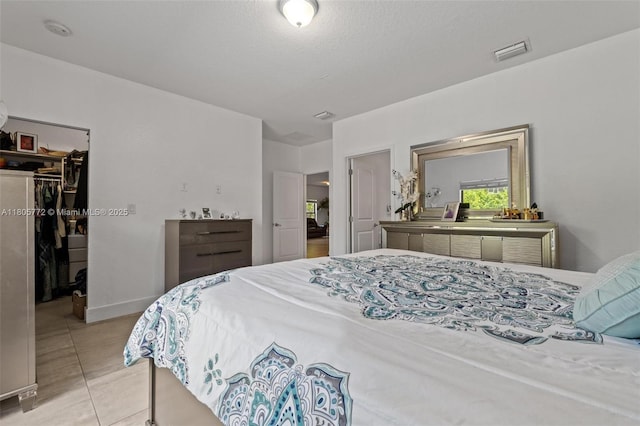 32004 SW 199th Ct, Homestead, FL 33030 - bedroom with a walk in closet, a closet, and light tile patterned floors
