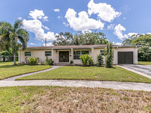 870 NE 182nd St, North Miami Beach, FL 33162 - ranch-style house featuring a garage, asphalt driveway, and a front lawn