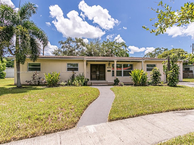 870 NE 182nd St, North Miami Beach, FL 33162 - single story home with a front yard, stucco siding, and french doors