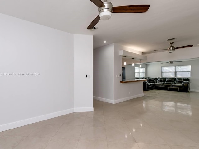 870 NE 182nd St, North Miami Beach, FL 33162 - unfurnished living room with ceiling fan, baseboards, and light tile patterned flooring
