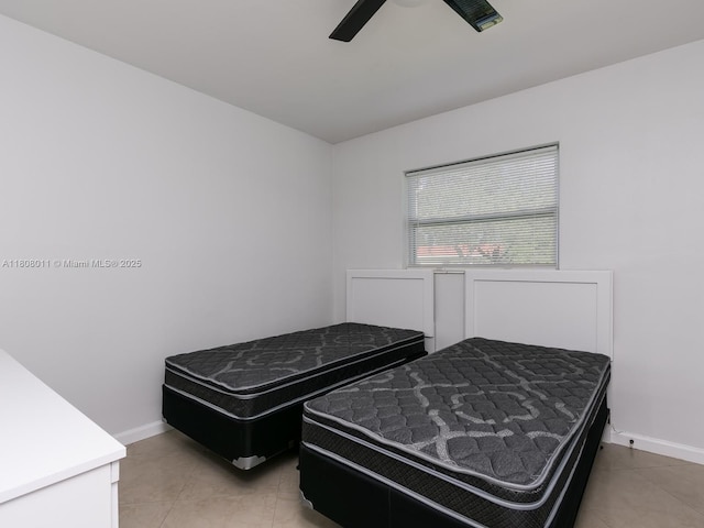 870 NE 182nd St, North Miami Beach, FL 33162 - bedroom featuring light tile patterned flooring, baseboards, and a ceiling fan