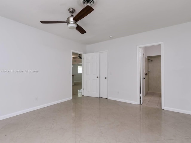 870 NE 182nd St, North Miami Beach, FL 33162 - unfurnished bedroom featuring baseboards, ensuite bathroom, tile patterned flooring, and ceiling fan