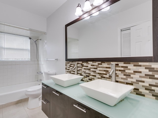 870 NE 182nd St, North Miami Beach, FL 33162 - full bath with decorative backsplash, double vanity, toilet, shower / bath combination, and tile patterned floors