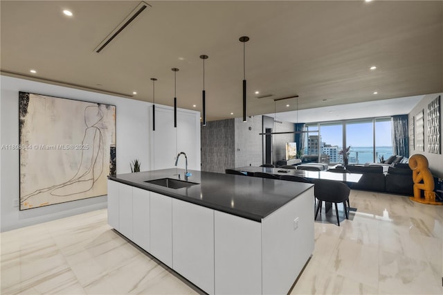 300 Biscayne Blvd Way Unit 3104, Miami, FL 33131 - kitchen featuring a sink, dark countertops, light marble finish floors, white cabinets, and recessed lighting