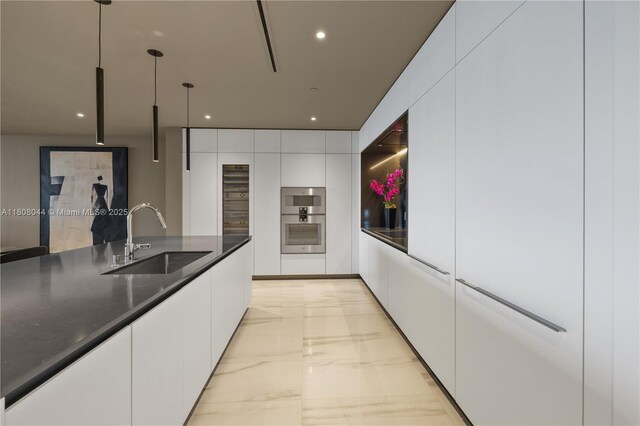 300 Biscayne Blvd Way Unit 3104, Miami, FL 33131 - kitchen with a sink, light marble finish flooring, modern cabinets, white cabinets, and dark countertops