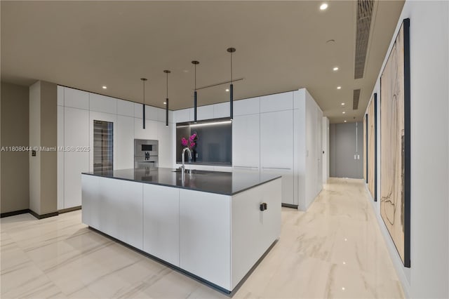 300 Biscayne Blvd Way Unit 3104, Miami, FL 33131 - kitchen with modern cabinets, light marble finish floors, white cabinetry, a spacious island, and a sink