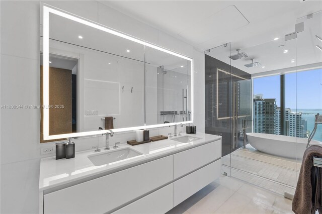 300 Biscayne Blvd Way Unit 3104, Miami, FL 33131 - full bathroom with double vanity, a soaking tub, a shower stall, tile patterned floors, and a water view