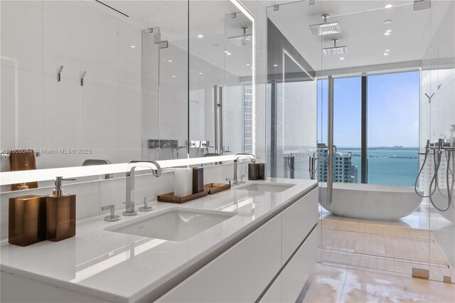 300 Biscayne Blvd Way Unit 3104, Miami, FL 33131 - full bathroom featuring a soaking tub, double vanity, a shower stall, a water view, and tile patterned floors
