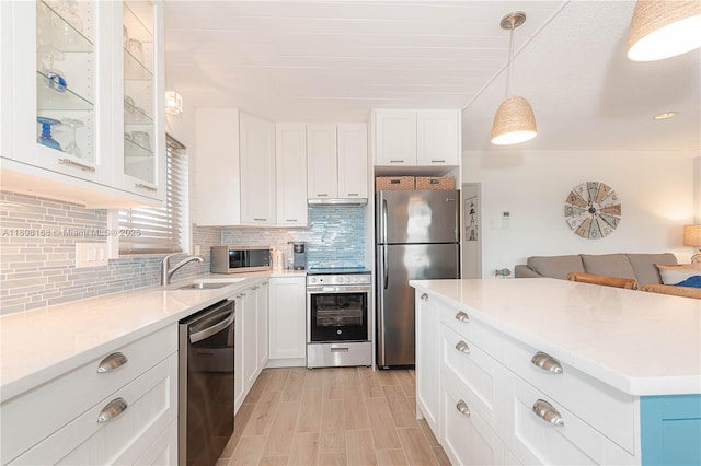 1050 SW 11th St Unit 20L, Hallandale Beach, FL 33009 - kitchen with stainless steel appliances, tasteful backsplash, white cabinetry, glass insert cabinets, and a sink