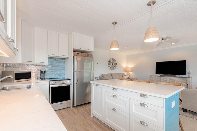 1050 SW 11th St Unit 20L, Hallandale Beach, FL 33009 - kitchen featuring appliances with stainless steel finishes, open floor plan, a sink, white cabinetry, and light countertops