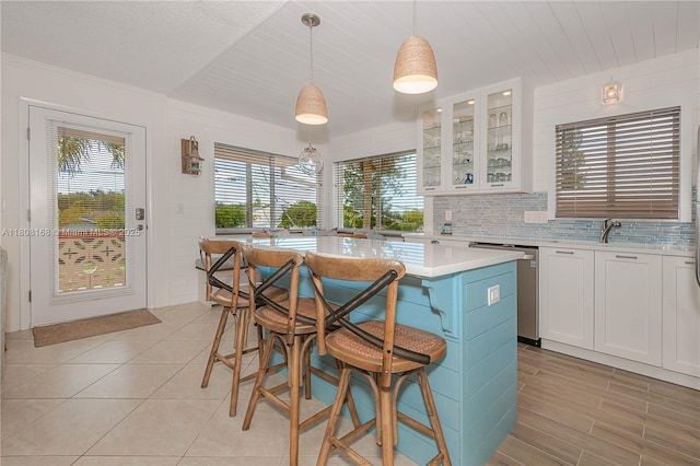 1050 SW 11th St Unit 20L, Hallandale Beach, FL 33009 - kitchen with stainless steel dishwasher, light countertops, white cabinets, and plenty of natural light