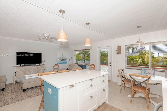 1050 SW 11th St Unit 20L, Hallandale Beach, FL 33009 - kitchen featuring open floor plan, white cabinets, light countertops, hanging light fixtures, and ornamental molding