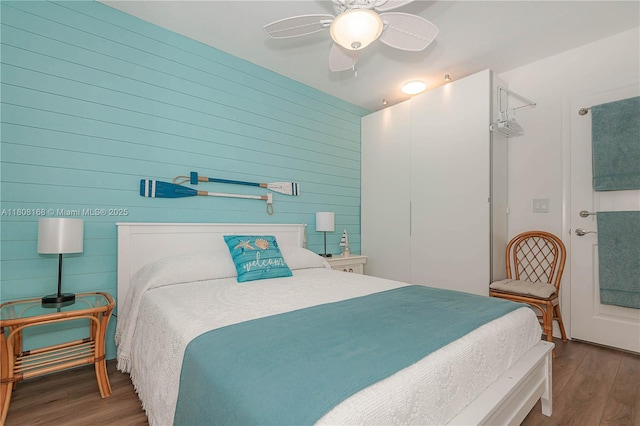 1050 SW 11th St Unit 20L, Hallandale Beach, FL 33009 - bedroom with wood finished floors, wooden walls, and ceiling fan