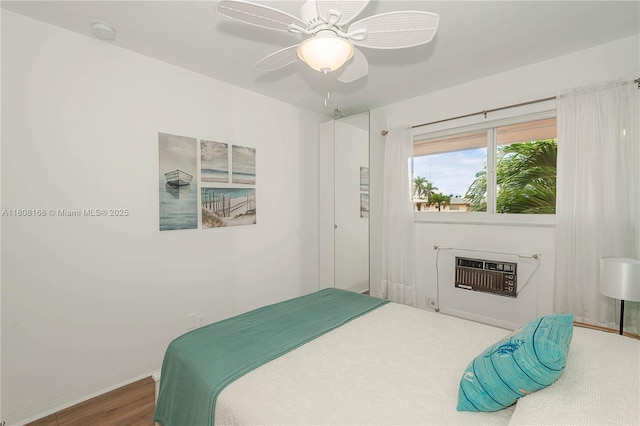 1050 SW 11th St Unit 20L, Hallandale Beach, FL 33009 - bedroom featuring a wall mounted AC, wood finished floors, baseboards, and ceiling fan