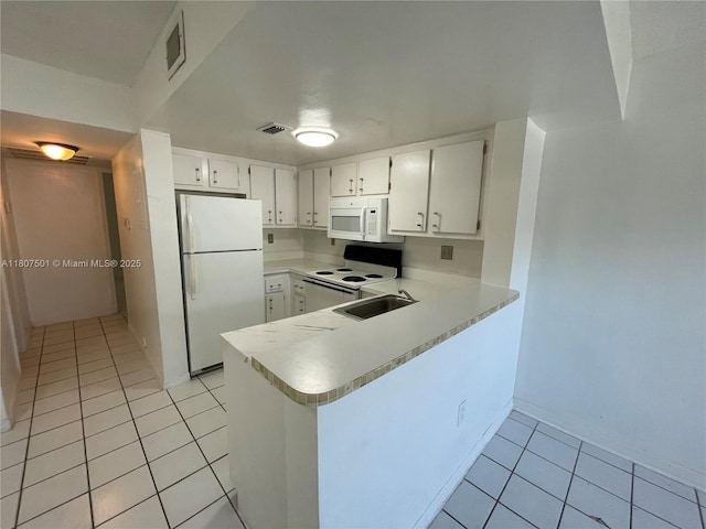 8670 NW 6th Ln Unit 4-103, Miami, FL 33126 - kitchen featuring white appliances, light tile patterned flooring, light countertops, a sink, and a peninsula