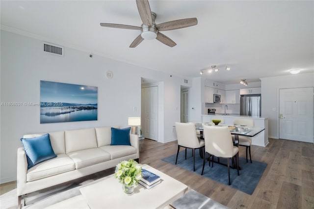 2665 SW 37th Ave Unit 906, Miami, FL 33133 - living room featuring a ceiling fan, light wood-style flooring, and crown molding