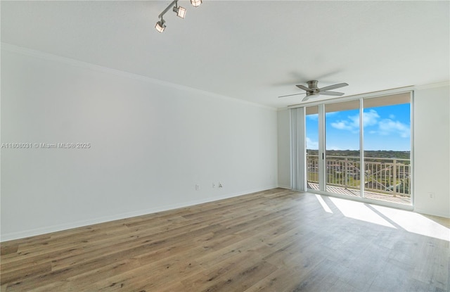 2665 SW 37th Ave Unit 906, Miami, FL 33133 - empty room with floor to ceiling windows, a ceiling fan, ornamental molding, wood finished floors, and baseboards