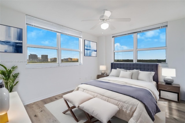 2665 SW 37th Ave Unit 906, Miami, FL 33133 - bedroom with wood finished floors, baseboards, and a ceiling fan