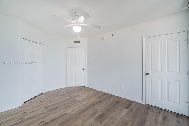 2665 SW 37th Ave Unit 906, Miami, FL 33133 - unfurnished bedroom with wood finished floors, baseboards, ceiling fan, and a closet