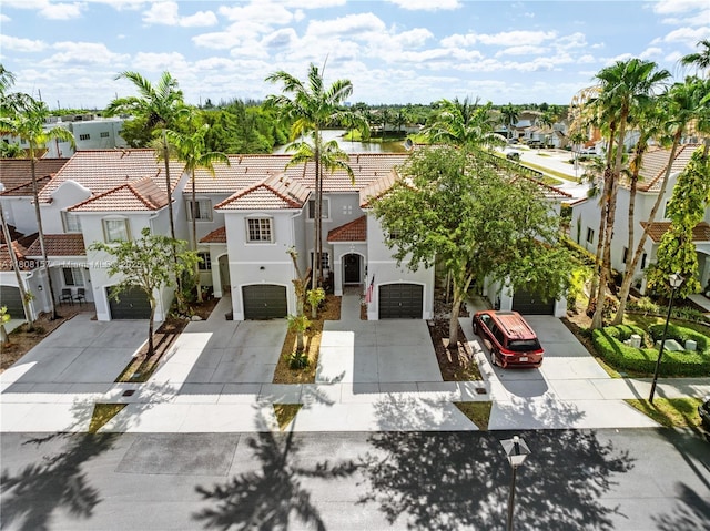 925 SW 147th Ct, Miami, FL 33194 - view of front of home featuring concrete driveway, stucco siding, a residential view, an attached garage, and a tiled roof