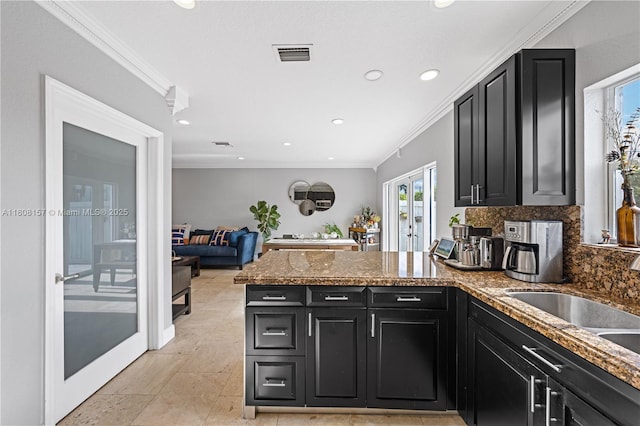 925 SW 147th Ct, Miami, FL 33194 - kitchen with dark cabinets, a peninsula, backsplash, french doors, and crown molding