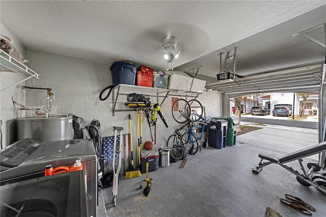 925 SW 147th Ct, Miami, FL 33194 - garage with washer / clothes dryer, a garage door opener, water heater, and a textured wall