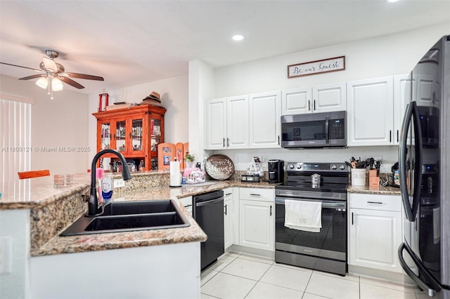 23558 SW 113th Psge, Homestead, FL 33032 - kitchen with appliances with stainless steel finishes, a sink, a peninsula, a ceiling fan, and white cabinetry