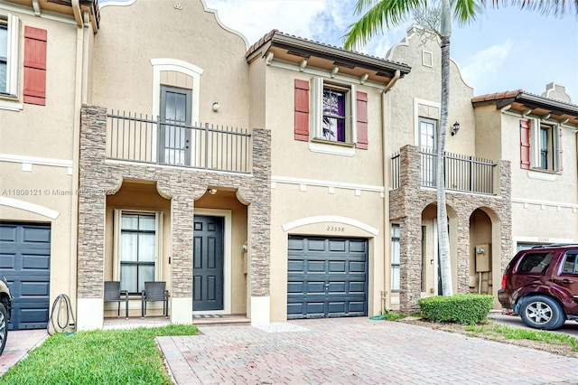 23558 SW 113th Psge, Homestead, FL 33032 - townhome / multi-family property featuring stone siding, a balcony, a garage, and stucco siding