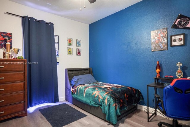 23558 SW 113th Psge, Homestead, FL 33032 - bedroom with wood finished floors, a ceiling fan, and baseboards