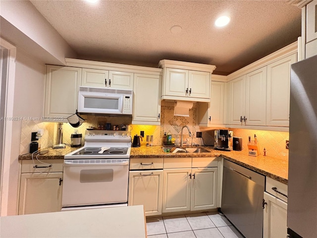 5183 Cannon Way, West Palm Beach, FL 33415 - kitchen with appliances with stainless steel finishes, a sink, recessed lighting, decorative backsplash, and a textured ceiling