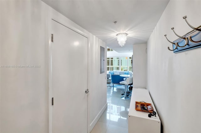 41 SE 5th St Unit 1012, Miami, FL 33131 - corridor with light tile patterned floors, a chandelier, and baseboards