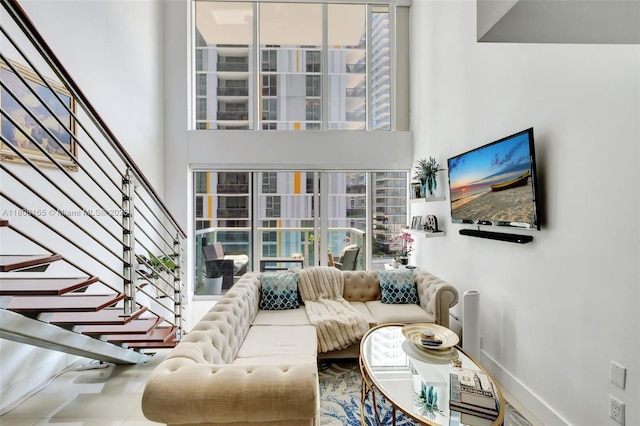 41 SE 5th St Unit 1012, Miami, FL 33131 - living area with stairs, healthy amount of natural light, a high ceiling, and baseboards