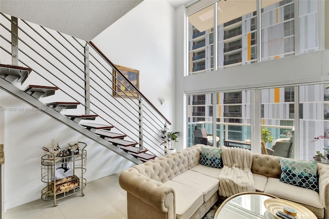41 SE 5th St Unit 1012, Miami, FL 33131 - living room featuring stairs, tile patterned floors, and a towering ceiling