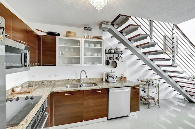 41 SE 5th St Unit 1012, Miami, FL 33131 - kitchen with dishwasher, stainless steel microwave, a sink, black electric cooktop, and a textured ceiling